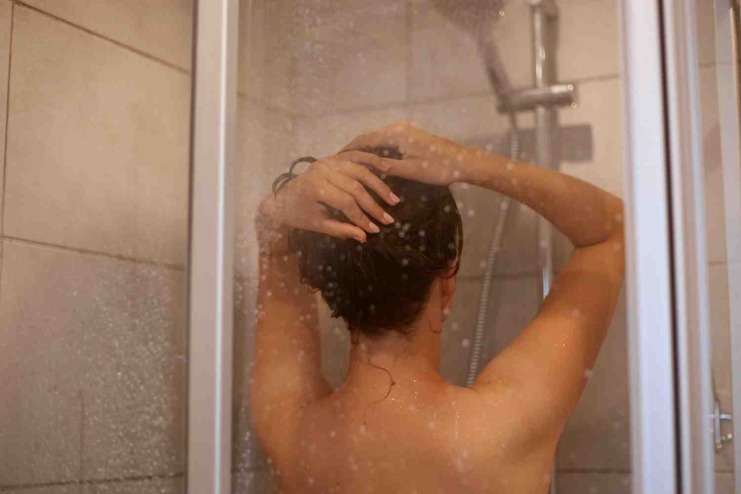 back-view-portrait-slime-woman-with-naked-shoulders-taking-shower-posing-backwards-bathroom-personal-hygiene-morning-procedures-hair-care-refreshment.jpg